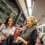 People on metro, using transit apps