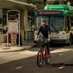 Capital Bikeshare rider in front of ART bus