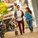 Pedestrians walking their dog